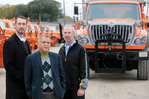 Kevin Scheibe, left, and Sree Nilakanta, center, both associate professors of information systems, have collaborated with David May, right, Iowa Department of Transportation fleet manager, on a project to save money on maintenance and replacement of snow plows. (Christopher Gannon/Iowa State University)