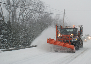 Plow on road during storm