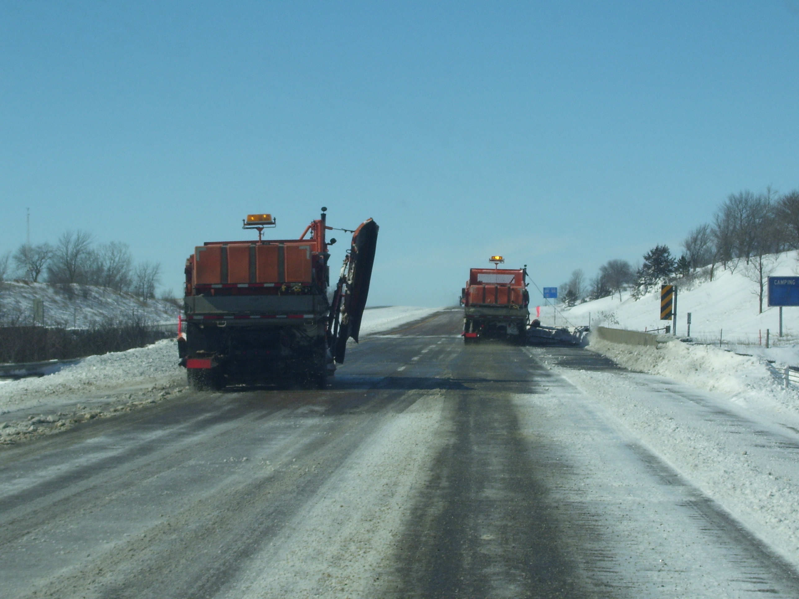 Snowplows clearing a street after a storm